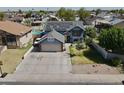 Expansive aerial view of a two-story home enhanced with solar panels and manicured landscaping at 8908 W Sheridan St, Phoenix, AZ 85037