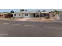 Quaint single-story home featuring a covered parking area, simple landscaping, and inviting curb appeal at 9726 E Quarterline Rd, Mesa, AZ 85207