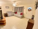 Cozy living room with comfortable seating, tile flooring, and natural light, great for relaxing at 9726 E Quarterline Rd, Mesa, AZ 85207