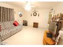 Bright living room featuring a comfortable couch, tile floors, and ceiling fan at 9726 E Quarterline Rd, Mesa, AZ 85207