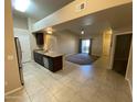 Spacious living area leading to kitchen with stainless steel appliances and granite countertops at 10136 E Southern Ave # 3109, Mesa, AZ 85209