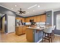 Open kitchen featuring wood cabinets, granite countertops, and stainless steel appliances at 10786 W Chisholm Dr, Sun City, AZ 85373