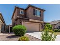 Two-story home featuring a tile roof, attached garage and desert landscaping at 10827 W Bronco Trl, Peoria, AZ 85383
