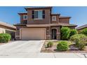 Two-story home featuring a tile roof, attached garage and desert landscaping at 10827 W Bronco Trl, Peoria, AZ 85383