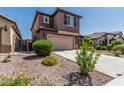 Two-story home featuring a tile roof, attached garage and desert landscaping at 10827 W Bronco Trl, Peoria, AZ 85383