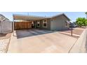 Spacious covered carport with a privacy fence and access to the home at 10951 N 91St Ave # 84, Peoria, AZ 85345