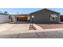 Charming home featuring a covered carport and low-maintenance landscaping at 10951 N 91St Ave # 84, Peoria, AZ 85345