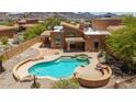 Aerial view of the backyard with a pool, spa, and desert landscaping at 11238 N 11Th St, Phoenix, AZ 85020