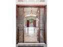 Inviting foyer with decorative glass doors, a high ceiling, and elegant tile flooring leading to the main living area at 12120 E Cortez Dr, Scottsdale, AZ 85259
