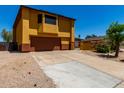 The home features an expansive driveway leading to a two-car garage, complemented by well-maintained landscaping at 12459 N 36Th St, Phoenix, AZ 85032