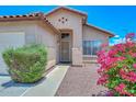 Inviting front entrance with well-kept landscaping and a charming facade at 1527 S 219Th Ln, Buckeye, AZ 85326