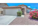Charming home featuring well-maintained landscaping and a two-car garage at 1527 S 219Th Ln, Buckeye, AZ 85326