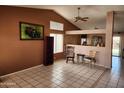 Open-concept living room with tile flooring, high ceilings, and an adjacent dining area bathed in natural light at 1643 E Oakland St, Chandler, AZ 85225