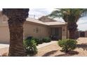 Beautiful front yard with lush green bushes and desert landscaping leading to a charming entry porch at 2004 N 108Th Dr, Avondale, AZ 85392