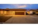 Home includes an attached garage with a modern door and plenty of space for parking and storage at 211 N 7Th St, Avondale, AZ 85323