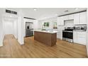 Bright, newly remodeled kitchen featuring stainless appliances, a spacious island, and modern white cabinets at 2201 N 29Th Pl, Phoenix, AZ 85008