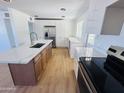 Contemporary kitchen with white cabinetry, stainless steel appliances, and a spacious island with a breakfast bar at 2201 N 29Th Pl, Phoenix, AZ 85008