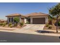 Attractive home exterior with a tile roof, a spacious driveway, and mature landscaping at 2750 W Pollack St, Phoenix, AZ 85041