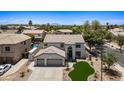 Spacious two-story home with a three-car garage, backyard pool, desert landscaping and well-manicured front yard at 2881 E Estrella Ct, Gilbert, AZ 85296