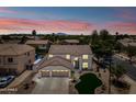 Stunning aerial view of a large two-story home with a three-car garage, desert landscaping, and a sparkling pool at 2881 E Estrella Ct, Gilbert, AZ 85296