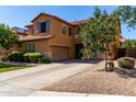 Beautiful home with a large driveway, two car garage and well manicured landscaping and desert rock at 3080 E Andre Ave, Gilbert, AZ 85298