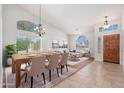 Elegant dining area flowing into the living room, featuring modern decor, neutral colors and lots of natural light at 3550 E Topeka Dr, Phoenix, AZ 85050