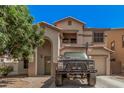 Charming two-story home with arched entry, balcony and basketball hoop over garage at 3625 W South Butte Rd, San Tan Valley, AZ 85144