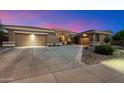 Charming home featuring desert landscaping, two car garage and wide driveway at 42105 N Golf Crest Rd, Anthem, AZ 85086