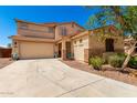 A charming two-story home with a neutral color scheme, a two-car garage, and desert landscaping at 42616 W Avella Dr, Maricopa, AZ 85138