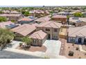 A beautiful home surrounded by a landscaped yard and other homes at 45647 W Starlight Dr, Maricopa, AZ 85139