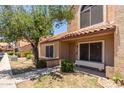 Charming home exterior with tile roof, mature tree, and desert landscaping at 4601 N 102Nd Ave # 1020, Phoenix, AZ 85037
