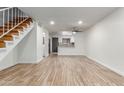 Open-concept living space features tile floors and a view of the staircase, kitchen, and entryway at 4601 N 102Nd Ave # 1020, Phoenix, AZ 85037