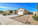 Front exterior view showcasing a well-maintained property with rock landscaping and curb appeal at 5316 N 186Th Dr, Litchfield Park, AZ 85340