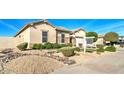Attractive home with desert landscaping, including decorative rock and green shrubbery at 5316 N 186Th Dr, Litchfield Park, AZ 85340