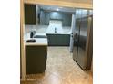 The kitchen has stainless steel appliances, ample storage, and neutral countertops at 6216 S 5Th Ave, Phoenix, AZ 85041