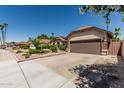 Single Gathering home showing lush garden, two-car garage and a large driveway at 717 N Mckemy Ave, Chandler, AZ 85226