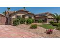 Landscaped front yard showing a stone-clad home with desert landscaping at 717 N Mckemy Ave, Chandler, AZ 85226