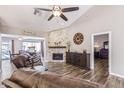 Cozy living room features a stone fireplace, wood flooring, and comfortable furnishings at 717 N Mckemy Ave, Chandler, AZ 85226