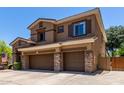 Two-story house featuring a three-car garage, stone accents, and an inviting facade at 723 E Gemini Pl, Chandler, AZ 85249