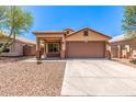 Single-story home featuring desert landscaping, a two-car garage, and a covered porch at 7419 W Raymond St, Phoenix, AZ 85043