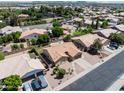 Expansive aerial view of a residential neighborhood showcasing single-story homes and community landscaping at 7736 W Tumblewood Dr, Peoria, AZ 85382