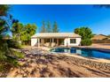 Sparkling pool and spa in a private backyard setting with a covered patio and mature landscaping at 780 W Morelos Ct, Chandler, AZ 85225