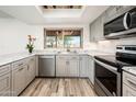 Modern kitchen with stainless steel appliances, granite countertops, and ample cabinet space at 11030 N 47Th Ave, Glendale, AZ 85304