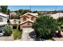 Aerial view of home showcasing a private backyard pool, lush landscaping, and a two-car garage at 111 N Soho Pl, Chandler, AZ 85225
