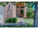 Inviting home entrance featuring a well-manicured lawn and shaded walkway at 111 N Soho Pl, Chandler, AZ 85225