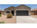 Charming single-story home featuring low-maintenance desert landscaping and a spacious two-car garage at 11303 E Sunflower Ct, Florence, AZ 85132