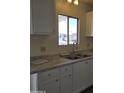 Kitchen featuring white cabinets, updated countertops, and a stainless steel sink at 11411 N 91St Ave # 188, Peoria, AZ 85345