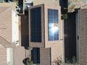 Rooftop solar panels, a modern energy solution for this beautiful home, seen from an aerial perspective at 11936 W Charter Oak Rd, El Mirage, AZ 85335