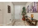 Inviting entryway with tiled floors, a console table, and tasteful decorations at 15532 W Prairie Dunes Dr, Surprise, AZ 85374