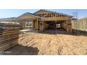 Exterior view of a new home under construction with wood framing and a garage at 15752 W Camden Ave, Waddell, AZ 85355